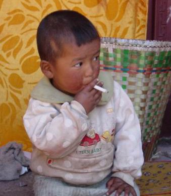 Young child holding a cigarette